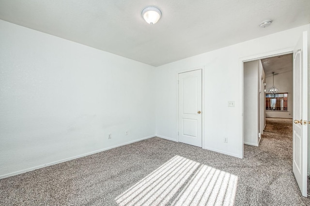 unfurnished bedroom featuring a closet and light colored carpet