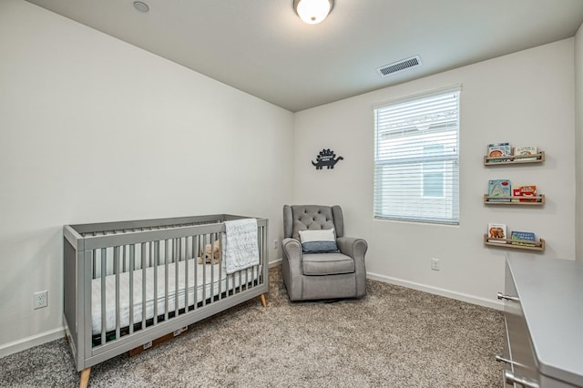 carpeted bedroom with a nursery area