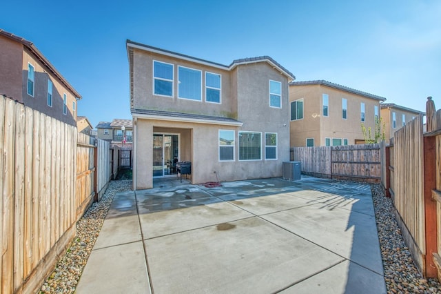 rear view of property with central air condition unit and a patio area