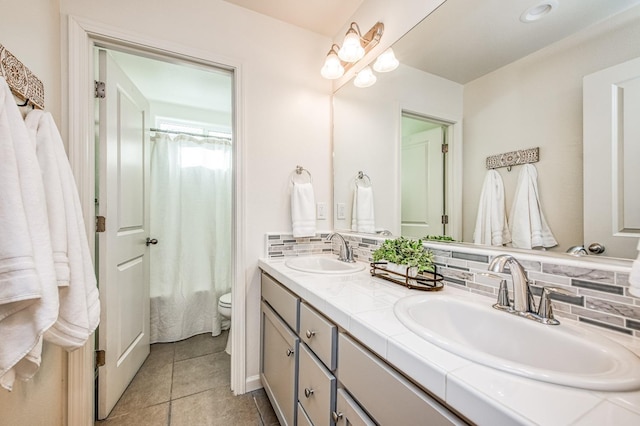 full bathroom with shower / tub combo, tile patterned floors, backsplash, toilet, and vanity