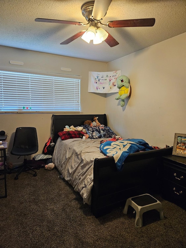 carpeted bedroom featuring ceiling fan and a textured ceiling