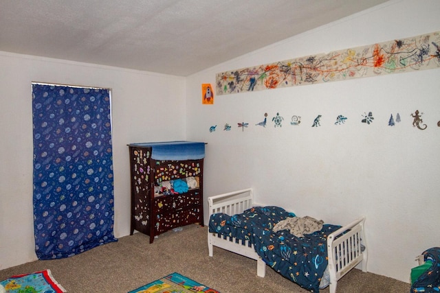 bedroom featuring lofted ceiling, a textured ceiling, and carpet