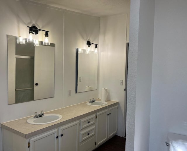 bathroom featuring toilet and vanity