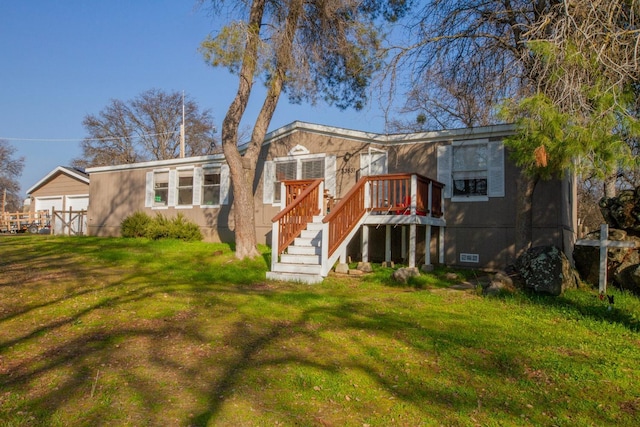 back of property featuring a deck and a yard