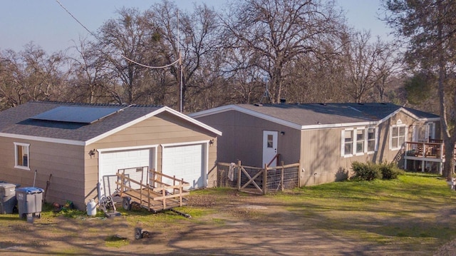 back of house featuring a garage