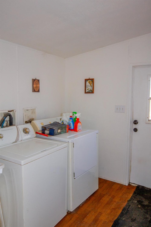 laundry area featuring washer and clothes dryer and wood-type flooring