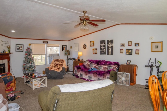 living room with vaulted ceiling, ceiling fan, a fireplace, a textured ceiling, and carpet floors