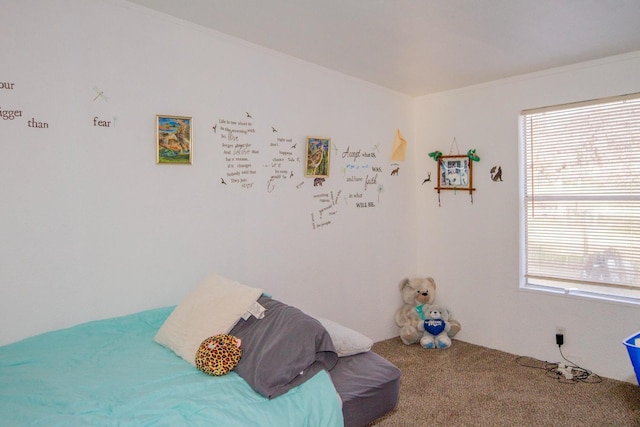 bedroom with multiple windows, carpet floors, and ornamental molding