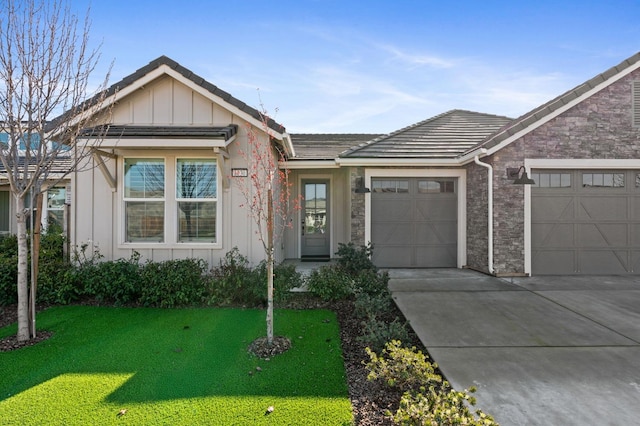 single story home with a front yard and a garage