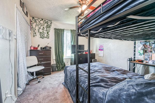 carpeted bedroom with ceiling fan and a textured ceiling