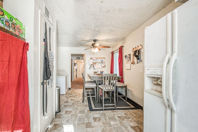 dining area featuring a textured ceiling and ceiling fan