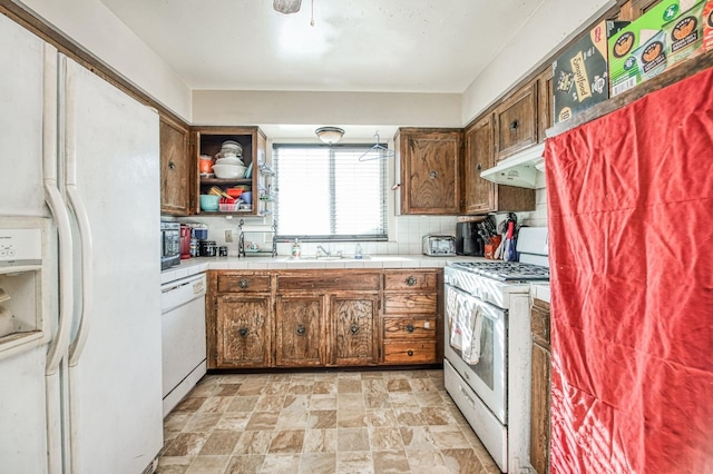 kitchen with sink, white appliances, tile countertops, and tasteful backsplash