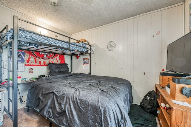 bedroom with wood walls, carpet, and a textured ceiling