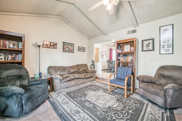 living room featuring ceiling fan, a textured ceiling, and lofted ceiling with beams