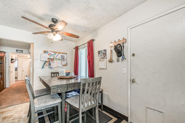 dining room with a textured ceiling and ceiling fan