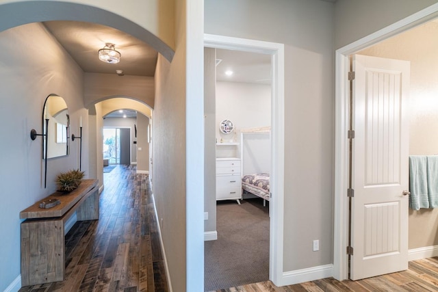 hallway with dark hardwood / wood-style flooring