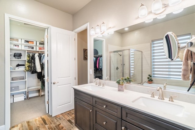 bathroom featuring vanity and an enclosed shower