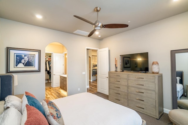 bedroom featuring ensuite bathroom, a closet, a spacious closet, and ceiling fan