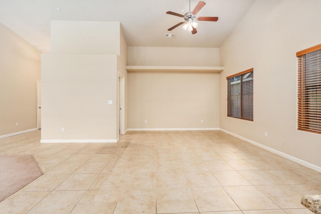 tiled empty room featuring ceiling fan