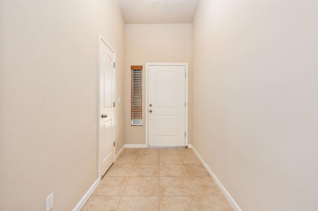 doorway to outside with light tile patterned floors