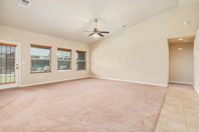 tiled empty room with ceiling fan and lofted ceiling