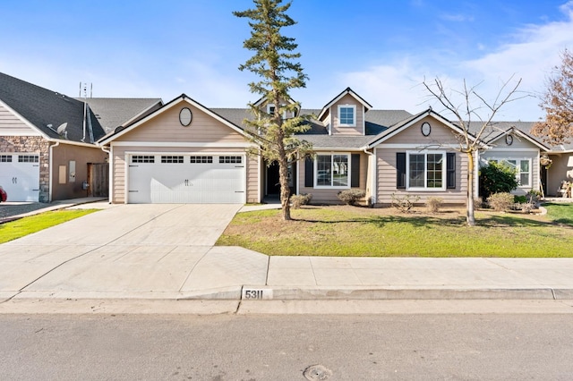 view of front of home with a garage and a front lawn