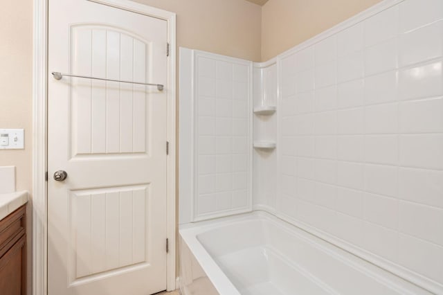 bathroom with vanity and  shower combination