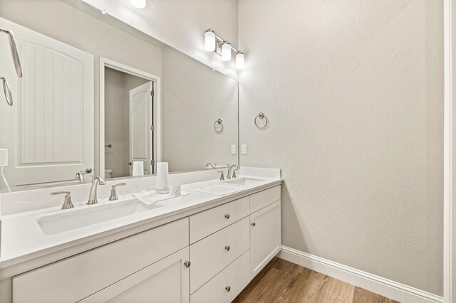 bathroom featuring hardwood / wood-style flooring, vanity, and toilet