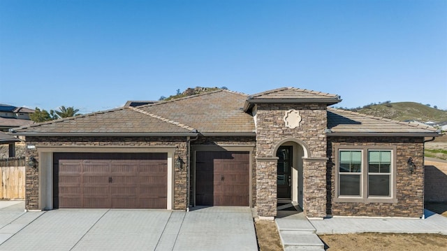 view of front of property featuring a garage and a mountain view