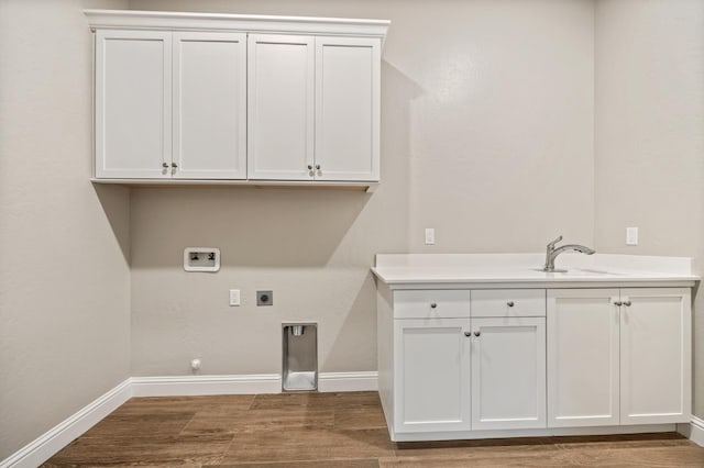 laundry area featuring gas dryer hookup, sink, cabinets, washer hookup, and electric dryer hookup