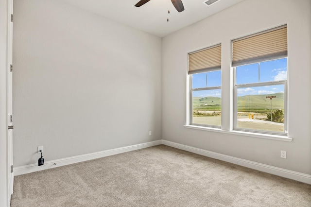 empty room with light colored carpet and ceiling fan