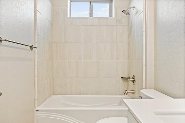 full bathroom with vanity, tiled shower / bath combo, and toilet