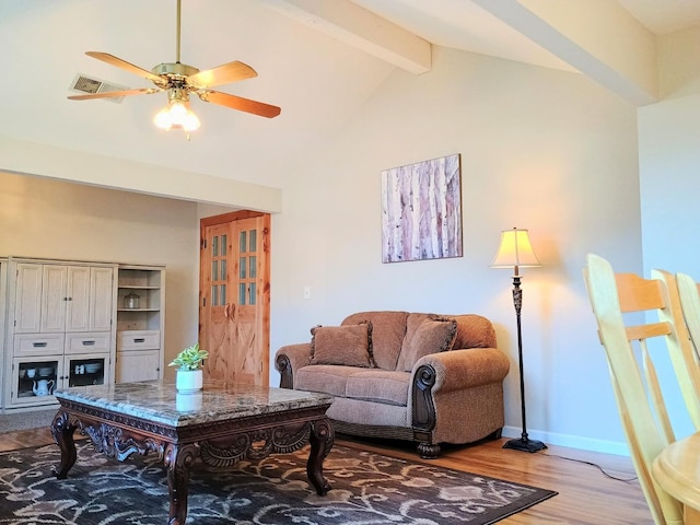 living room featuring high vaulted ceiling, beam ceiling, light hardwood / wood-style floors, and ceiling fan