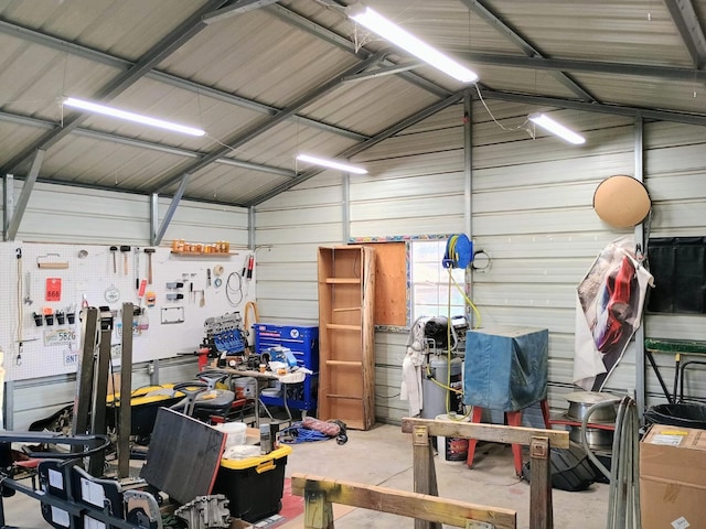 garage with a workshop area and metal wall