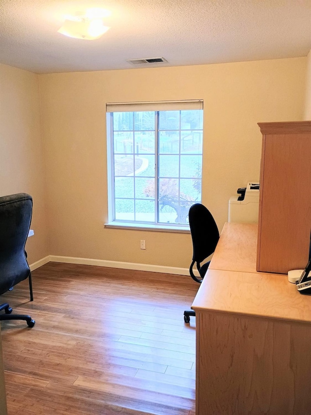 office space with hardwood / wood-style flooring and a textured ceiling