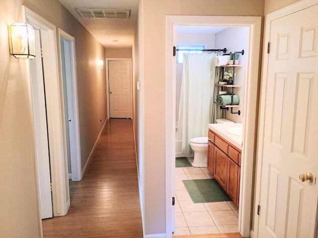 corridor featuring light tile patterned floors