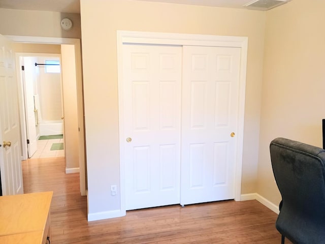 home office featuring light wood-style flooring, baseboards, and visible vents
