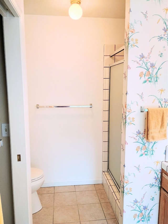 bathroom with tile patterned flooring, an enclosed shower, and toilet