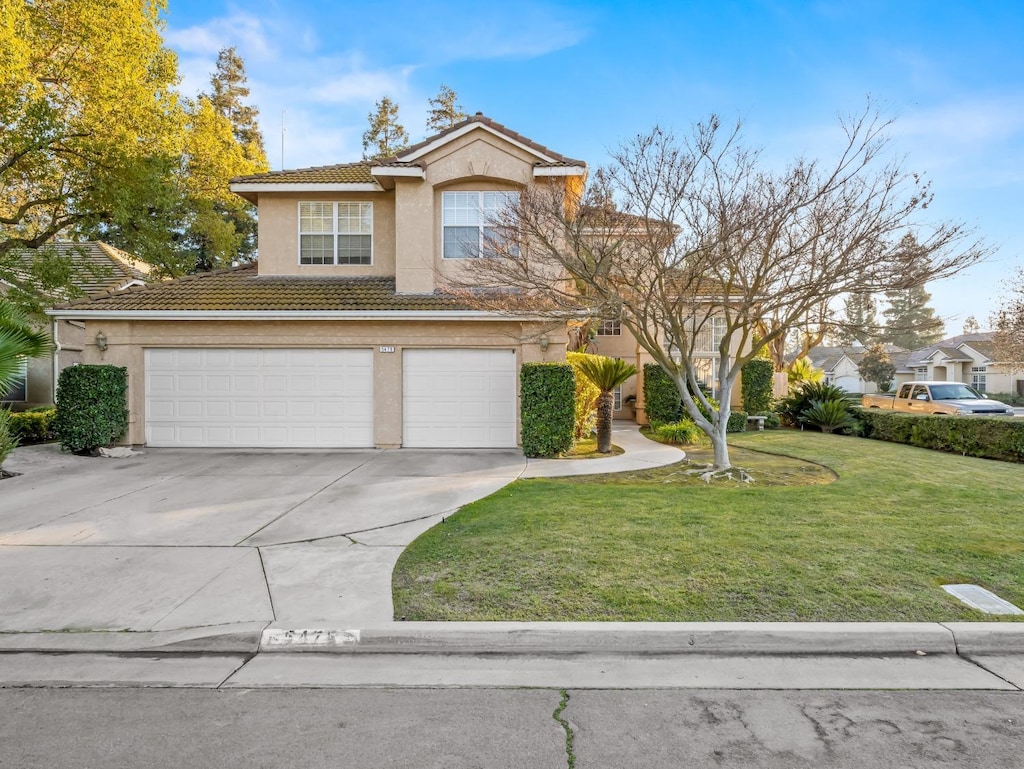 front of property featuring a garage and a front yard