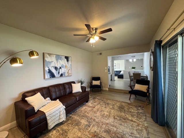 living room with hardwood / wood-style floors and ceiling fan