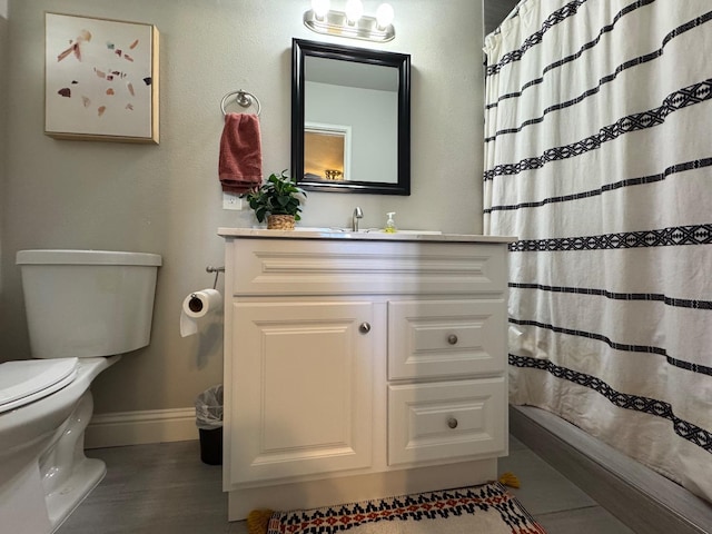 bathroom featuring curtained shower, toilet, and vanity