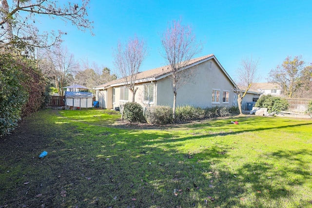 rear view of house featuring a lawn