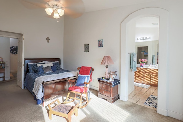 bedroom with ceiling fan, vaulted ceiling, and light tile patterned floors