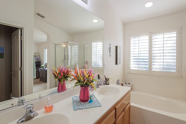 bathroom with vanity and plus walk in shower