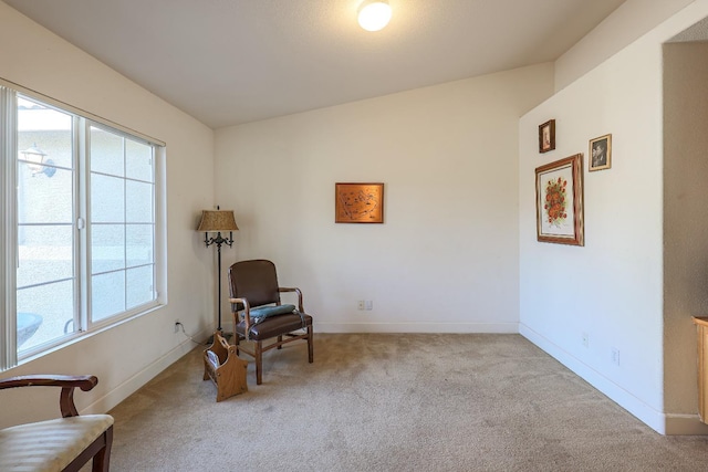 sitting room with light carpet and lofted ceiling