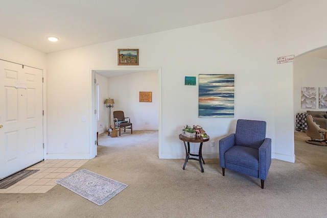 living area featuring light carpet and lofted ceiling