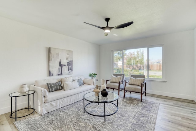 living room with light wood-type flooring and ceiling fan