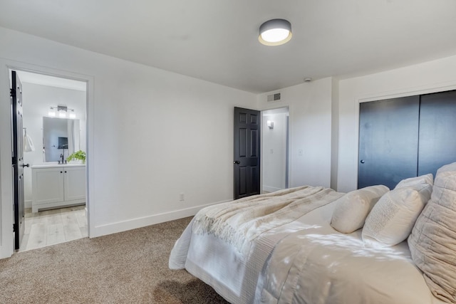 carpeted bedroom featuring ensuite bathroom