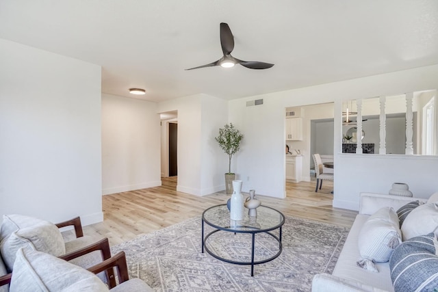 living room featuring light wood-type flooring and ceiling fan