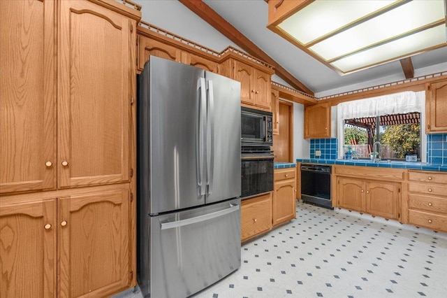 kitchen featuring black appliances, lofted ceiling, sink, backsplash, and tile countertops